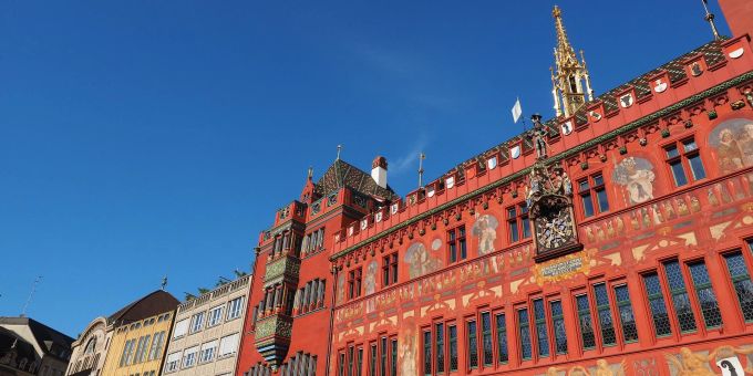 Das Rathaus ist eine besondere Attraktion in Basel. Rathaus Basel rot Himmel blau