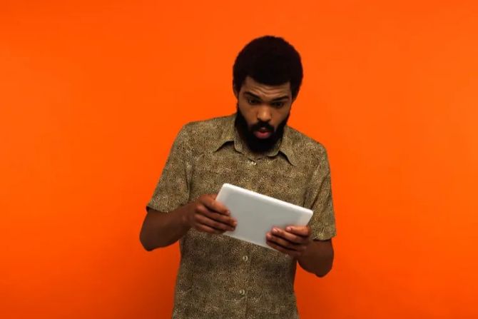 Junger Mann Tablet erstaunter Blick