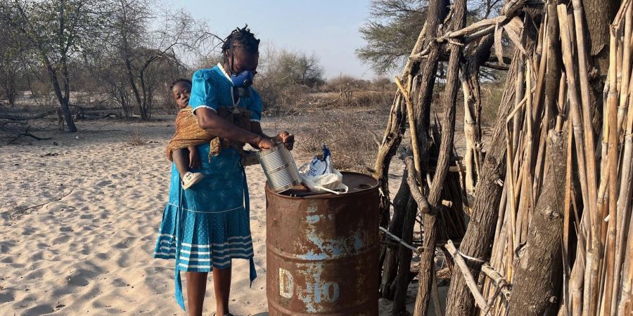 Landwirtin Rebecca Gatshele bereitet ein Gemisch aus Chili und Elefantendung zu, dass sie auf ihrem Feld verbrennt, um Elefanten davon abzuhalten, ihre Ernte zu fressen.