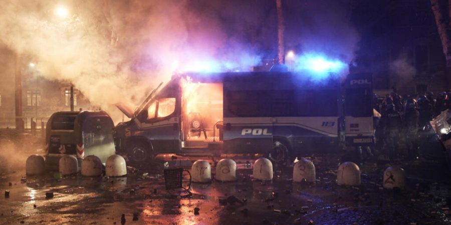 Ein Polizeifahrzeug brennt bei Ausschreitungen nach einer Demonstration gegen die Räumung des linken Zentrums Askatasuna. Das Jugendzentrum war Ende Dezember geräumt worden. Foto: Mar...