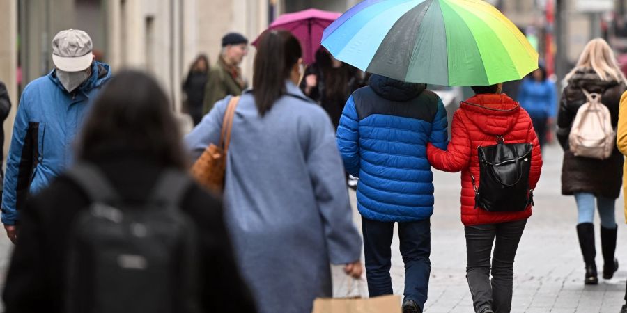 Zahlreiche Menschen gehen durch eine Einkaufsstrasse in Köln.