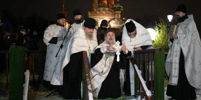 Ein russisch-orthodoxer Priester segnet am Dreikönigstag das eiskalte Wasser in der Kirche der Heiligen Dreifaltigkeit in Moskau. Foto: Alexander Zemlianichenko/AP/dpa russisch orthodox
