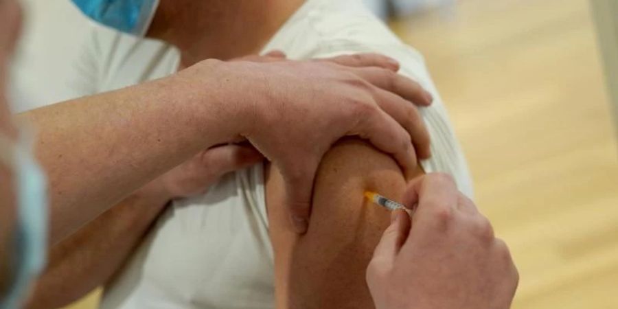 Ein Mann lässt sich in einem Hamburger Fitnessstudio gegen das Coronavirus impfen. Foto: Marcus Brandt/dpa