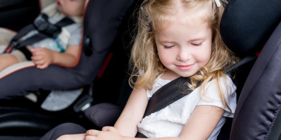 Kinder sollten niemals alleine im Auto gelassen werden, da das Auto überhitzen kann oder Kinderdiebe vorbeikommen können.