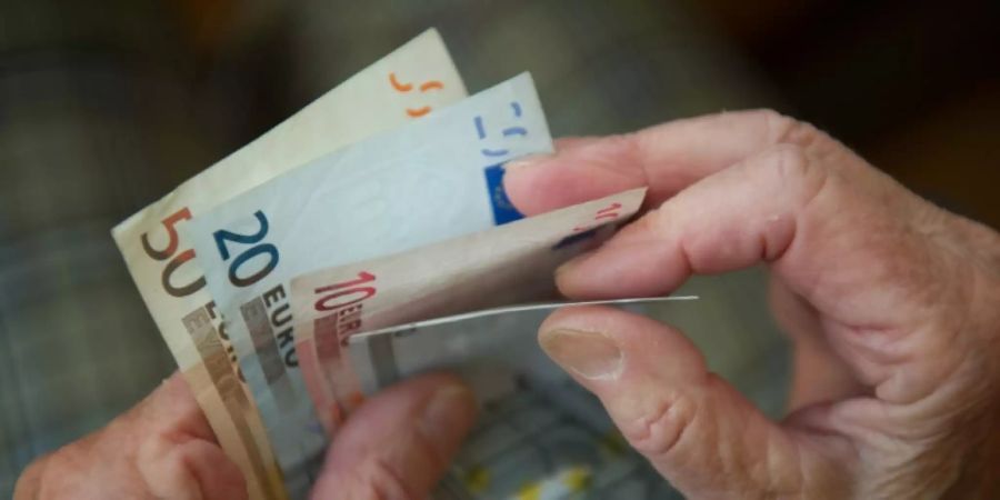 Rentnerin zählt ihr Geld