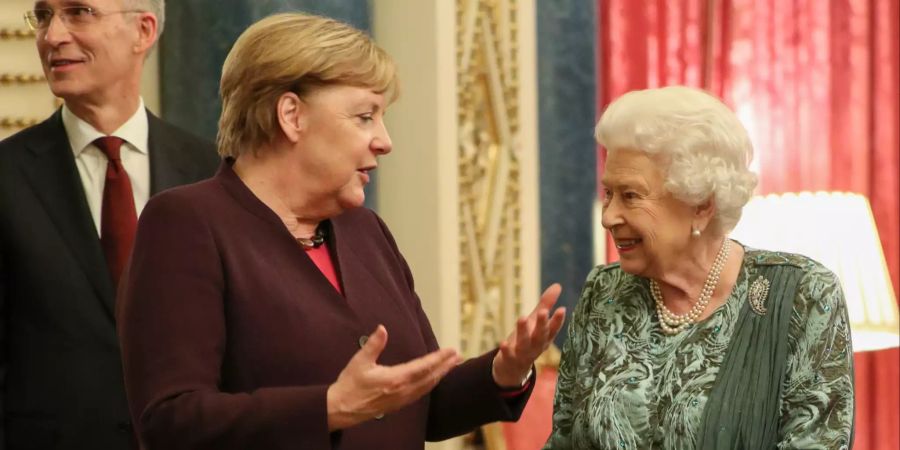 Bundeskanzlerin Angela Merkel (CDU) spricht mit der britischen Königin Elizabeth II. während eines Empfangs im Buckingham Palace, vor Beginn des eigentlichen Nato-Gipfels.