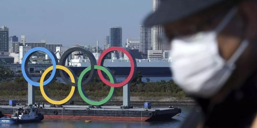 Die Austragung der Olympischen Spiele ist weiter umstritten. Foto: Eugene Hoshiko/AP/dpa