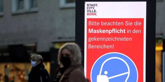 Frauen stehen neben einem Hinweisschild zur Maskenpflicht an einer Haltestelle in Bonn. Die Länder fordern vor den Beratungen mit Kanzlerin Merkel strengere Kontaktbeschränkungen, um die hohen Coronazahlen zu senken. Foto: Oliver Berg/dpa Frauen stehen neben einem Hinweisschild zur Maskenpflicht an einer Haltestelle in Bonn. Die Länder fordern vor den Beratungen mit Kanzlerin Merkel strengere Kontaktbeschränkungen, um die hohen Coronazahlen zu senken. Foto: Oliver Berg/dpa
