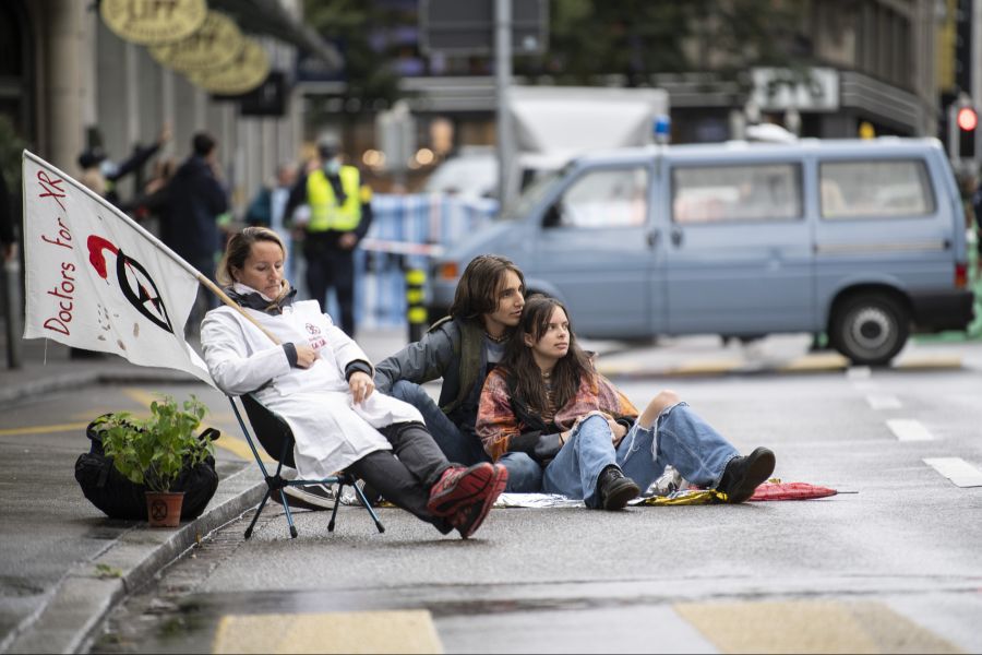 Sie setzen sich mit Transparenten und Campingstühlen auf die Strasse.