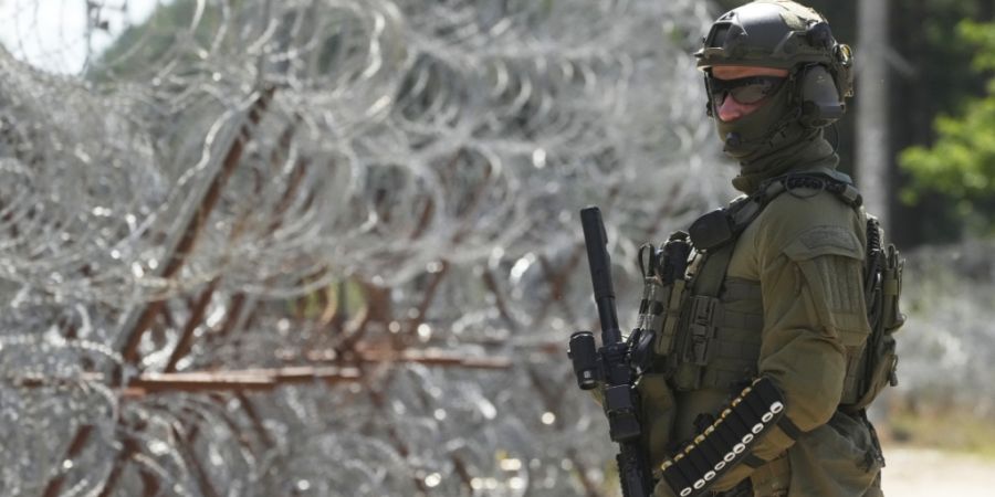 ARCHIV - Ein polnischer Grenzschutzbeamter steht an der polnisch-belarussischen Grenze (Archivbild). Foto: Czarek Sokolowski/AP/dpa