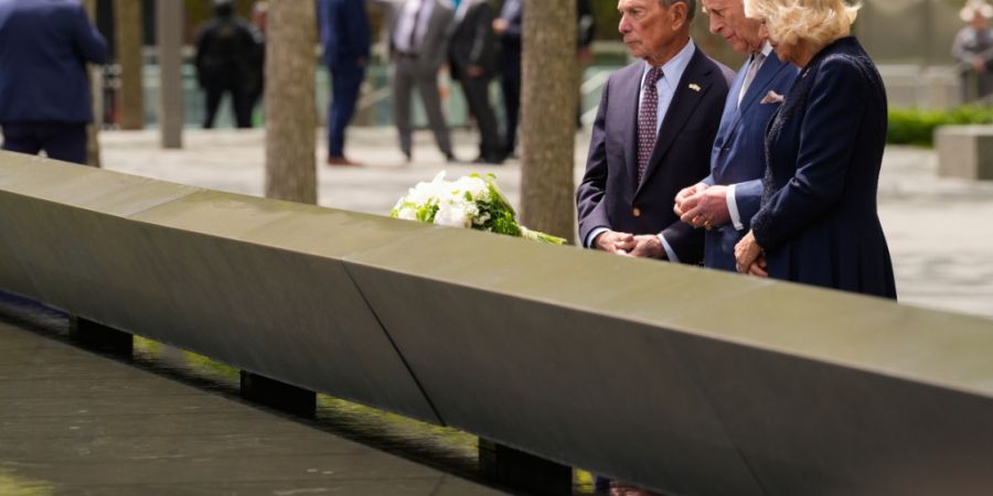 Großbritanniens König Charles III. (M) und Königin Camilla besuchen das 9/11 Memorial mit dem ehemaligen Bürgermeister von New York City, Michael Bloomberg. Foto: Seth Wenig/AP/dpa