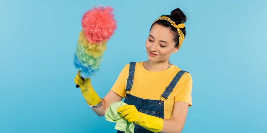 Frau mit Staubwedel in der Hand