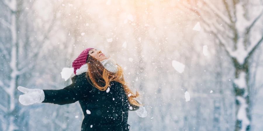 Frau breitet Arme aus, Spaziergang im Schnee