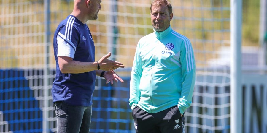Schalkes Sportdirektor Rouven Schröder (l) im Gespräch mit Schalkes Cheftrainer Frank Kramer.