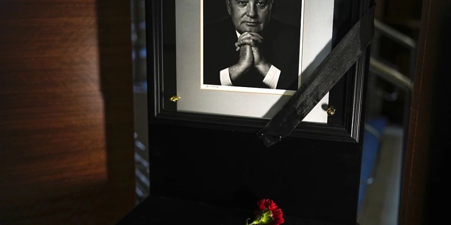 dpatopbilder - Ein Porträt von Michail Gorbatschow und Blumen am Sitz seiner Stiftung. Foto: Alexander Zemlianichenko/AP/dpa - ACHTUNG: Nur zur redaktionellen Verwendung und nur mit vollständiger Nennung des vorstehenden Credits