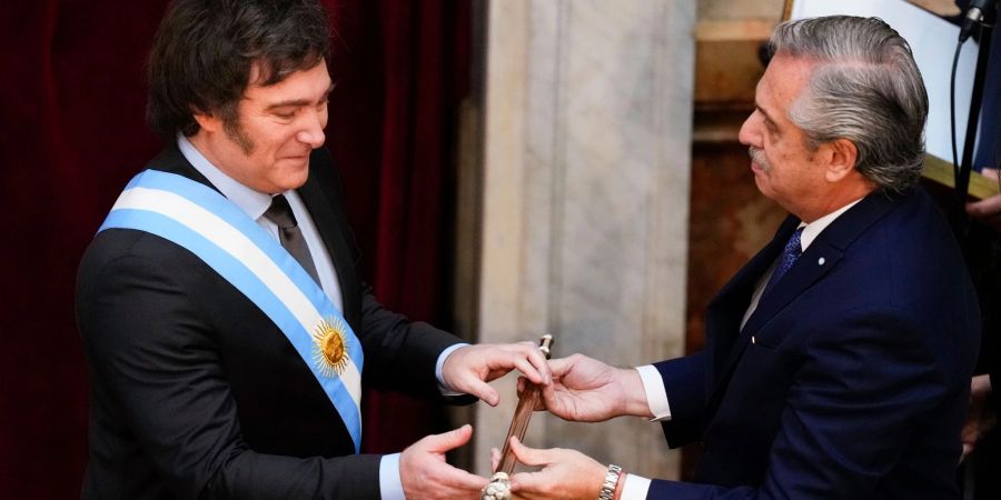 Javier Milei (l) erhält den Präsidentenstock von seinem Amtsvorgänger Alberto Fernandez.