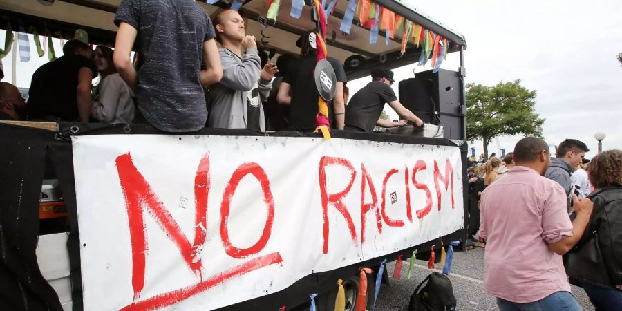 «No racism» steht bei einer Parade gegen Rassismus an einem Wagen auf der Hafenstrasse.