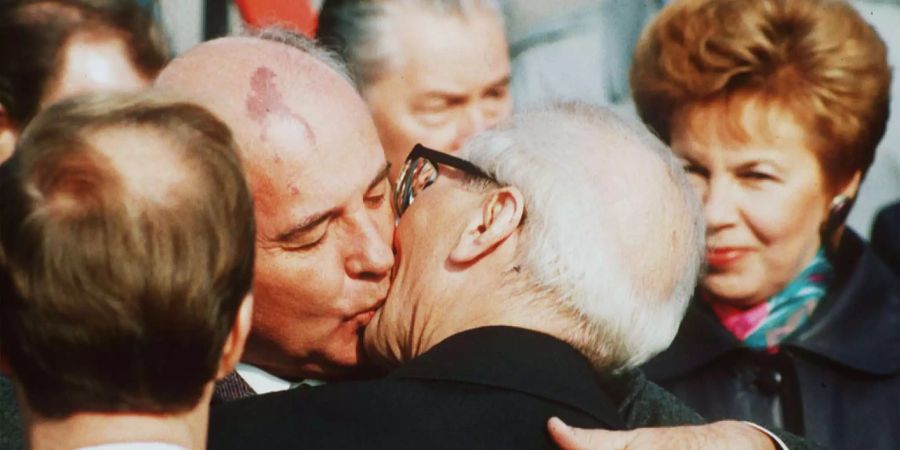 Der Präsident der Sowjetunion Michail Gorbatschow umarmt den Parteivorsitzenden der DDR Erich Honecker.