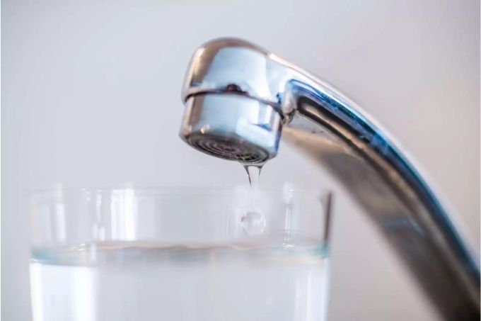 Wasserhahn lässt noch die letzten Tropfen Wasser in ein Glas fallen - Keystone Wasserhahn lässt noch die letzten Tropfen Wasser in ein Glas fallen - Keystone