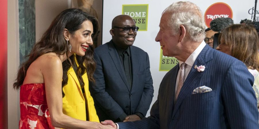 Amal Clooney und König Charles geben sich die Hand.