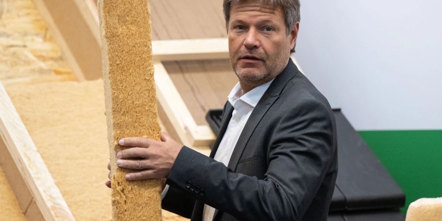 Robert Habeck (Bündnis 90/Die Grünen), Bundesminister für Wirtschaft und Klimaschutz, hält bei einem Rundgang über die Internationale Handwerksmesse (IHM) hält eine Dämmplatte aus Holzfasern in den Händen.