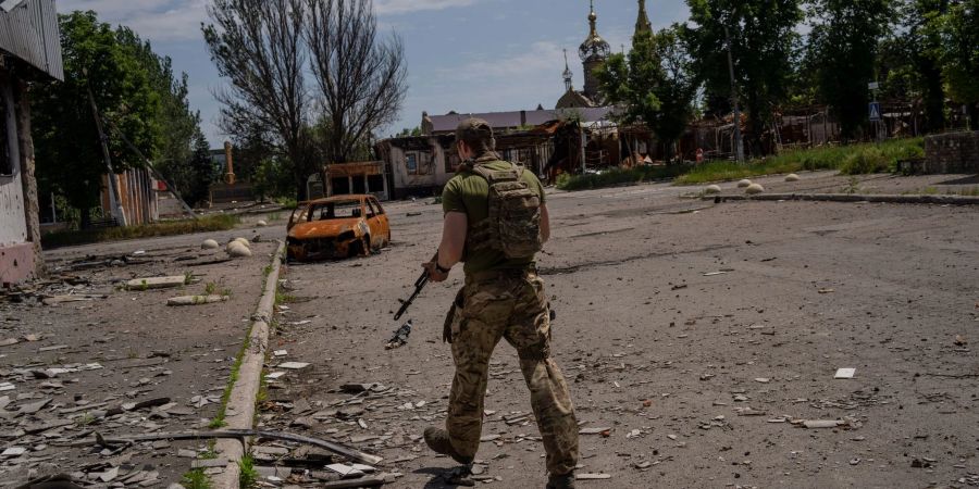 Ein ukrainischer Soldat patrouilliert in einem Dorf nahe der Frontlinie im Gebiet Donezk im Osten der Ukraine.