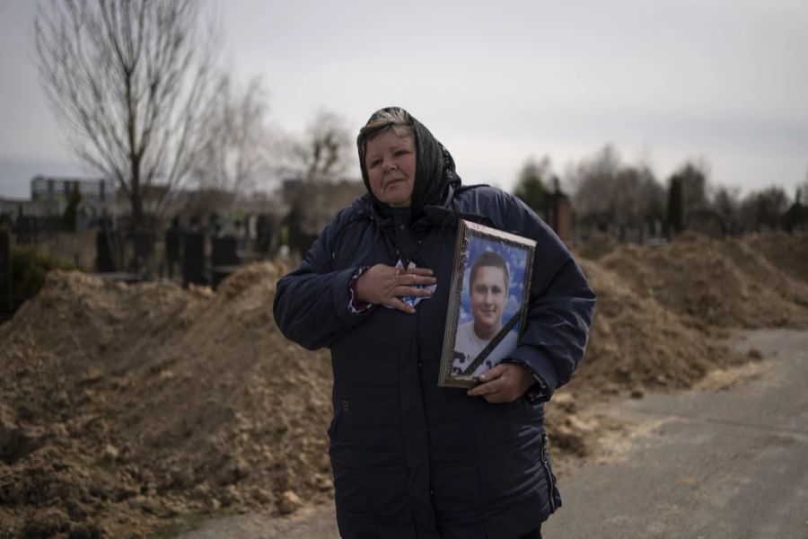 Eine Frau trägt das Bild eines in Butscha getöteten Zivilisten auf sich. In Butscha haben russische Truppen ein besonders grauenhaftes Blutbad hinterlassen.