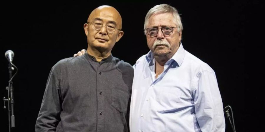 Liao Yiwu (l) und Wolf Biermann bei Lesung und Konzert «Wer sich nicht in Gefahr begibt, der kommt drin um!» in Berlin. Foto: Fabian Sommer/dpa