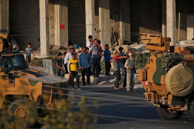 Anwohner der Grenzstadt zu Syrien beobachten einen Konvoi türkischer Truppenfahrzeuge. Militäroffensive der Türkei