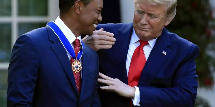 US-Präsident Donald Trump (r) verleiht Golfstar Tiger Woods die Presidential Medal of Freedom. Foto: Manuel Balce Ceneta/AP
