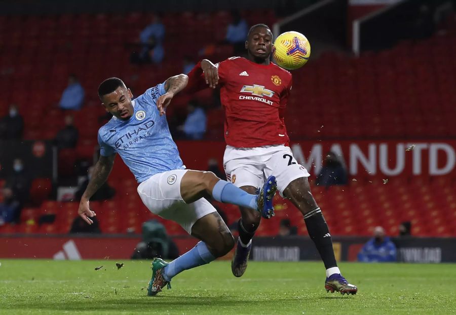 City-Stürmer Gabriel Jesus (l.) wird beim Abschluss von United-Verteidiger Aaron Wan-Bissaka (r.) gestört.