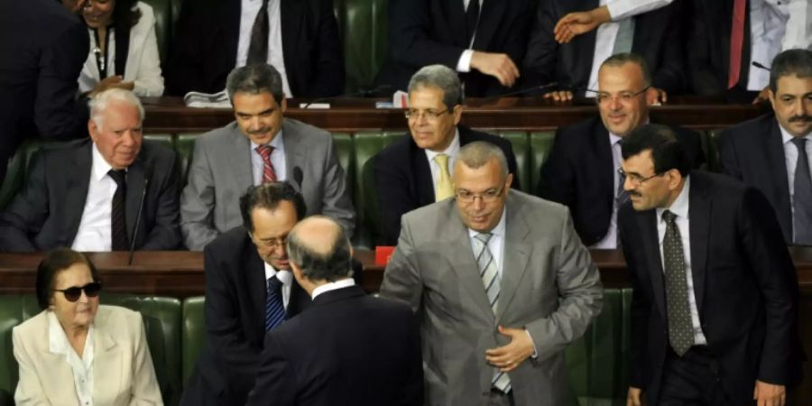 In this file photo taken on July 5, 2013, then French foreign affairs minister Laurent Fabius (front) greets Noureddine Bhiri (2R) with other Tunisian politicians in Tunisia's Constituent Assembly