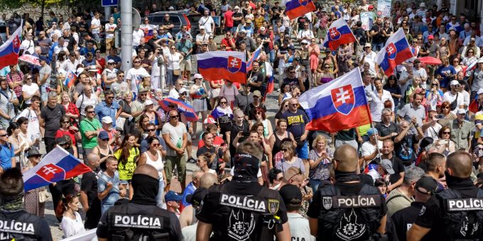 24 July 2021, Slovakia, Bratislava: Police officers stand guard outside the National Council in Bratislava, during a protest against the coronavirus restrictions. Photo: Dano Veselský/TASR/dpa protest against coronavirus restrictions in Bratislava