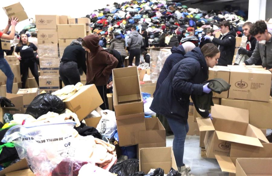 Einige Hilfsgüter schaffen es jedoch nicht über die Grenzen. Abgebildet: Menschen in Bosnien sortieren Hilfsgüter für die Erdbebenopfer.