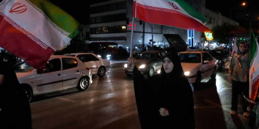 ARCHIV - Frauen halten iranische Fahnen bei einer Pro-Regierungskampagne in der Innenstadt von Teheran. Foto: Vahid Salemi/AP/dpa