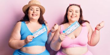 Junge Plus-Size-Zwillinge im Bikini mit Bordkarte