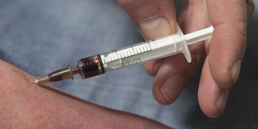 ARCHIV - Ein Drogensüchtiger spritzt sich einen Schuss Heroin in den Unterarm - viele Menschen sind wegen dieser Droge gestorben. Foto: Boris Roessler/dpa