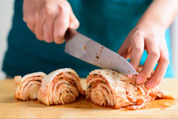 In der Zubereitung speziell - und vielfältig: Es gibt über hundert Arten von Kimchi. Frau bereitet Kimchi zu