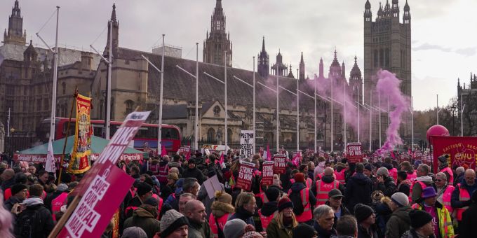 Royal Mail workers gather in Parliament Square, as they hold a protest over pay and jobs, in London, Friday, Dec. 9, 2022. The Communications Workers Union (CWU) has planned six days of strike over pay. (AP Photo/Alberto Pezzali) Britain Postal Workers Strike