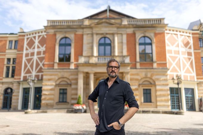 Der Regisseur Roland Schwab steht vor dem Festspielhaus in Bayreuth. Bayreuth