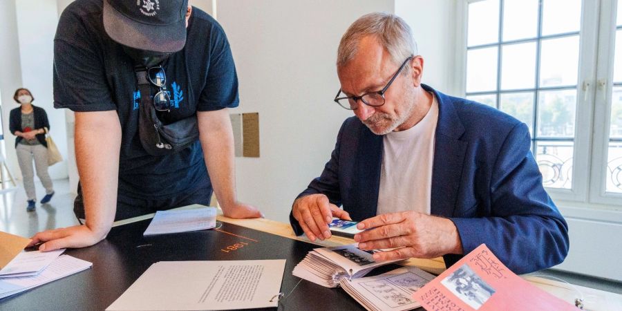 Volker Beck betrachtet die umstrittene Broschüre der Initiative «Archives des luttes des femmes en Algérie» auf der documenta