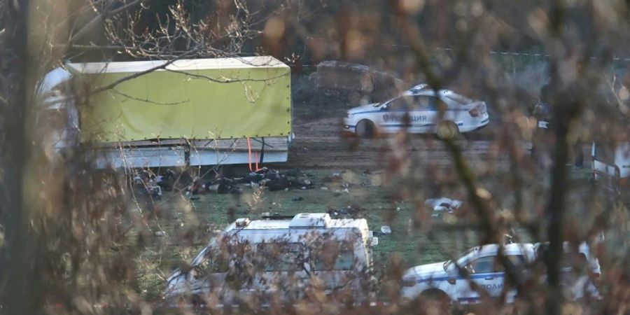 Polizeiautos stehen um einen Lkw