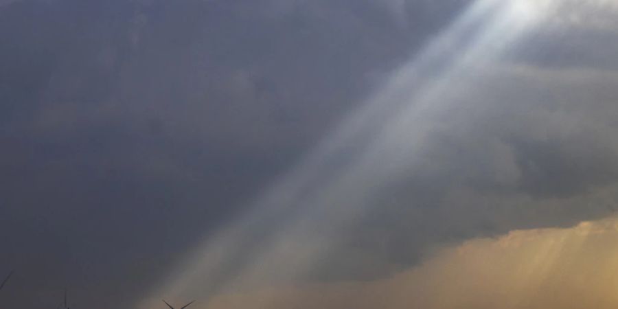 Das Sonnenlicht fällt durch die Sturmwolken, während südlich von Stuart im US-Bundesstaat Iowa heftige Unwetter über den Mittleren Westen ziehen. Foto: Chris Machian/Omaha World-Herald/AP/dpa - ACHTUNG: Nur zur redaktionellen Verwendung und nur mit vollständiger Nennung des vorstehenden Credits