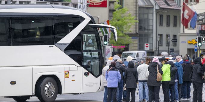 Ein Reisecar und Bus auf dem Löwenplatz in der Stadt Luzern. Seit 1. April 2025 erhebt die Stadt Luzern eine Haltegebühr für Reisebusse. Reisecar
