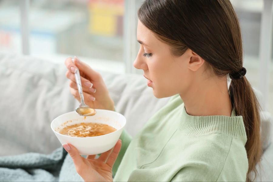Junge Frau mit Suppe