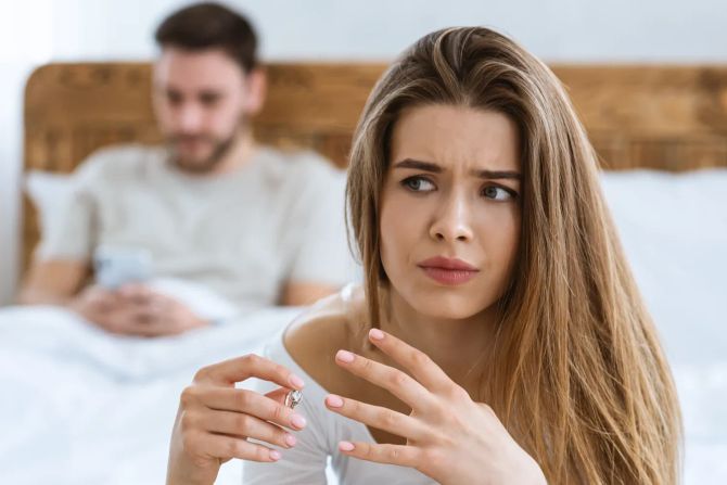 Nachdenkliche Frau, Mann im Hintergrund