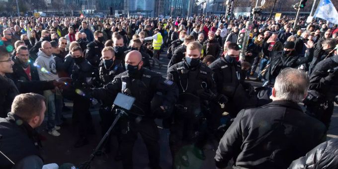 Polizisten stehen während der Demonstration der Stuttgarter Initiative ·Querdenken· auf dem Augustusplatz vor Gegendemonstranten. An der Kundgebung gegen die von Bund und Ländern beschlossenen Corona-Massnahmen nehmen mehrere Tausend Menschen teil. Foto: Sebastian Kahnert Demonstration «Querdenken» in Leipzig