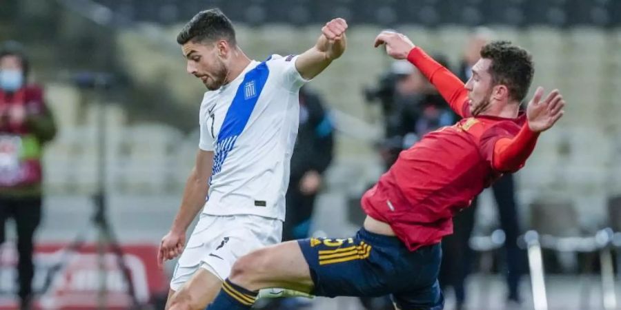 Griechenlands Giorgos Masouras (l) wird vom Spanier Aymeric Laporte attackiert. Foto: Thanassis Stavrakis/AP/dpa