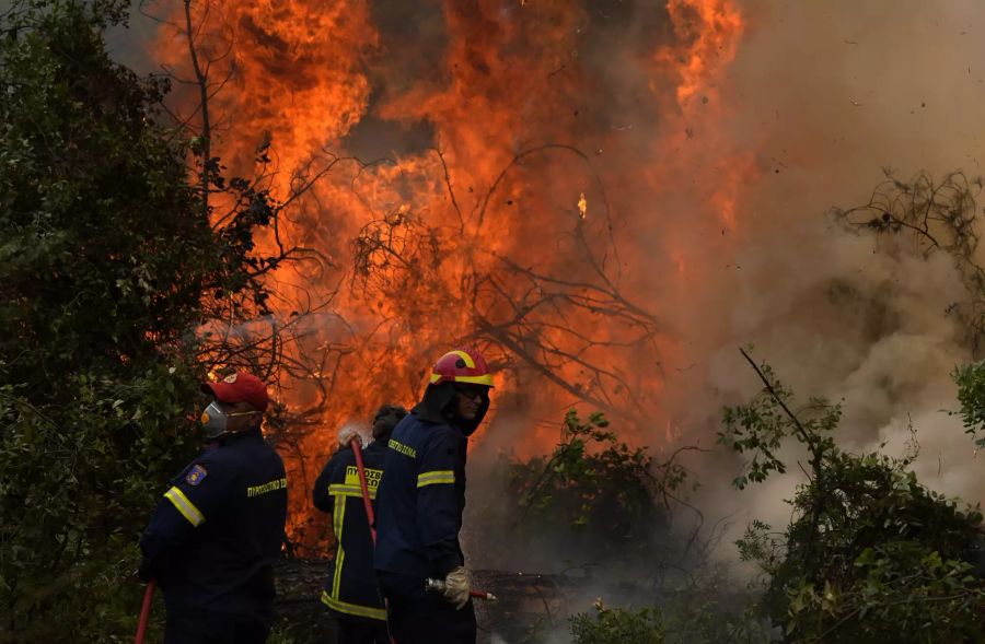 Feuerwehrleute versuchen, die Flammen im Dorf Ellinika zu löschen.