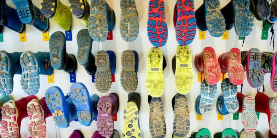 Gummistiefel von Kindern an der Wand einer Kita. Foto: Rolf Vennenbernd/ dpa